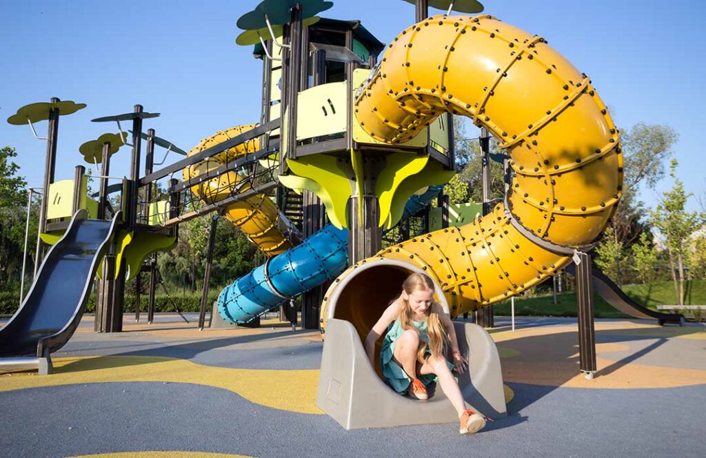 girl at the large beautiful playground in the park